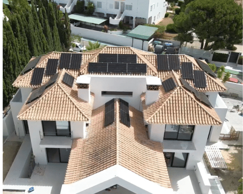A detailed architectural model of a modern residential complex with tiled roofs and solar panels.